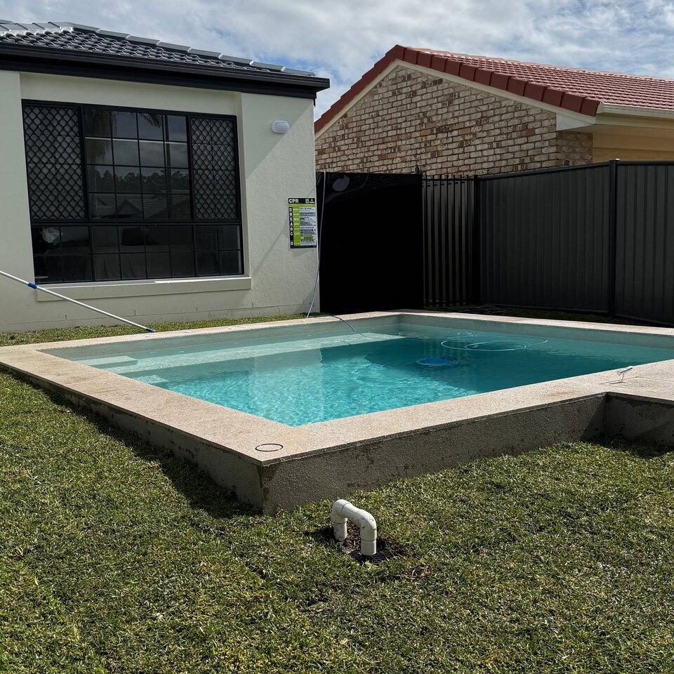 Lawn surrounding an outdoor pool area